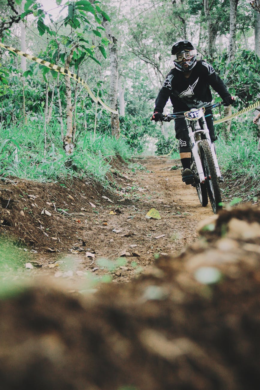 shallow focus photo of person riding bike